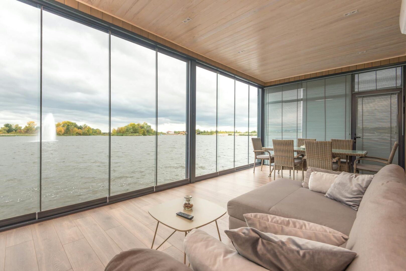 A living room with large windows and a couch